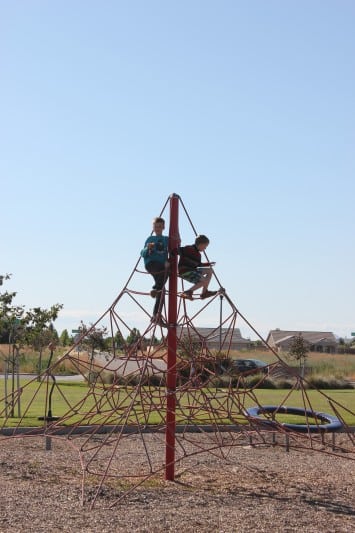 kids on playground climbing structure