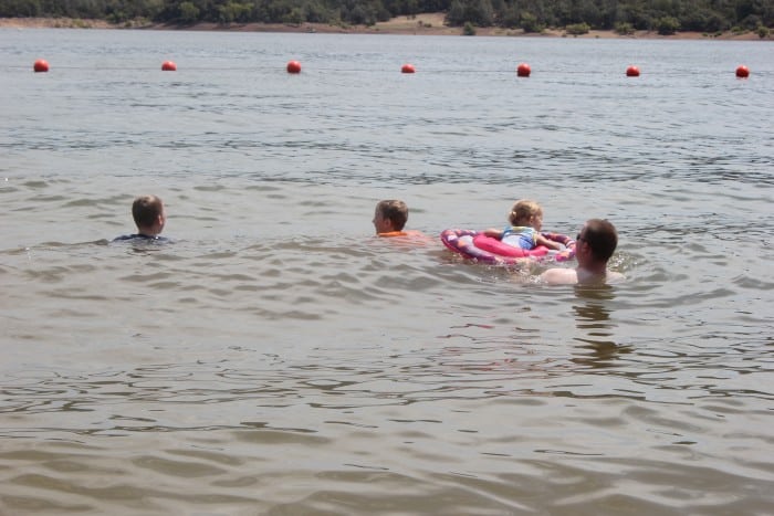 kids playing in lake summer bucket list activity