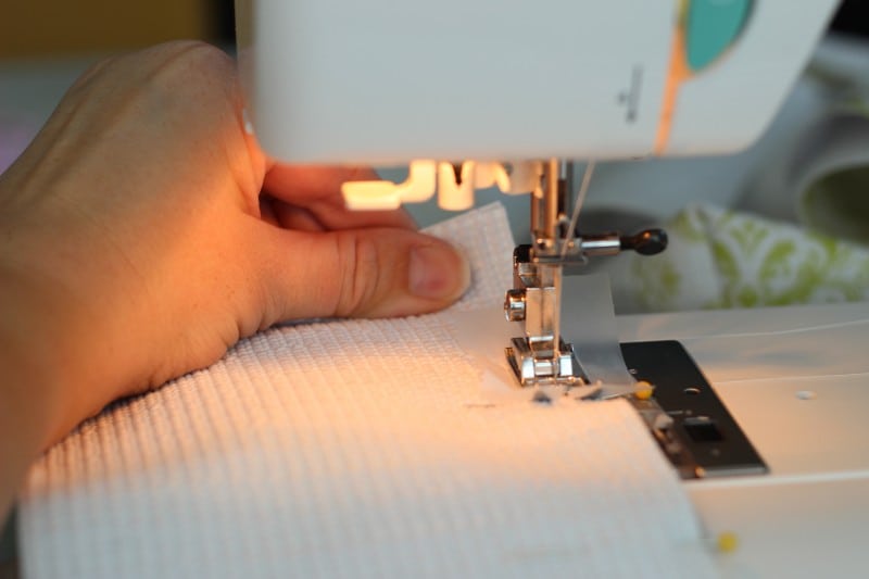 sewing machine stitching side of tote 