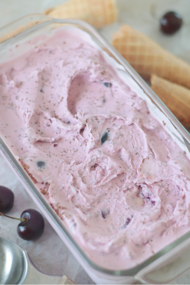 glass loaf pan full of cherry ice cream