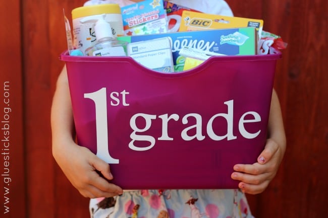 little girl holding school supplies tote