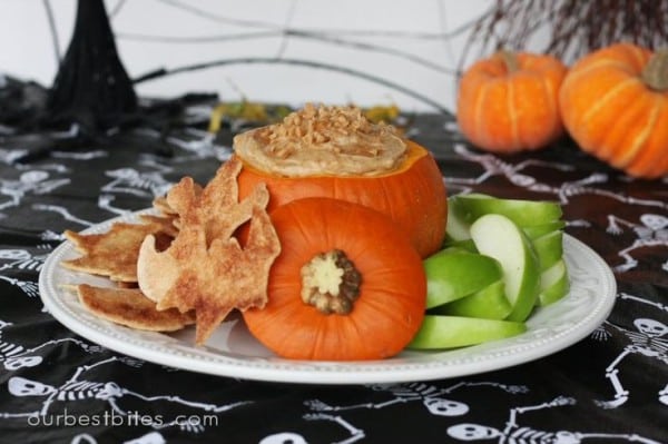 caramel dip inside pumpkin with apple slices for halloween classroom parties