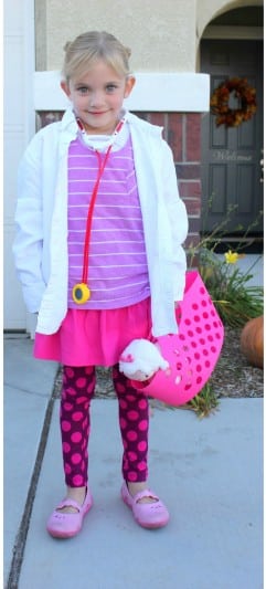 little girl wearing doc mcstuffins costume