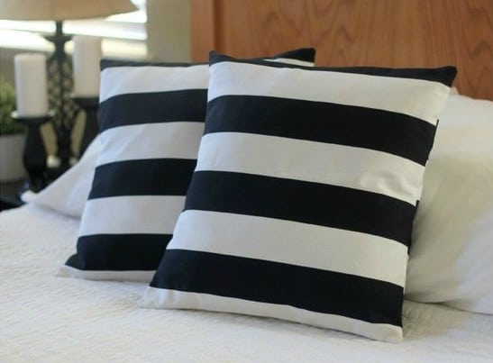 two striped throw pillows on bed