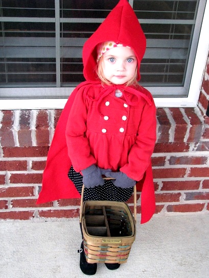 little girl wearing little red riding hood costume