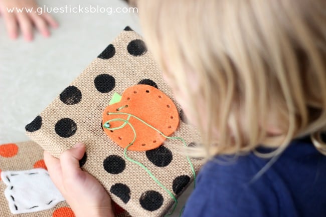 little girl sewing through felt