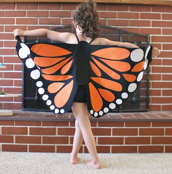 little girl wearing butterfly costume