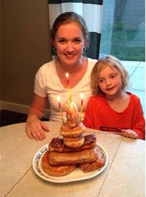 mom and little girl with donut cake