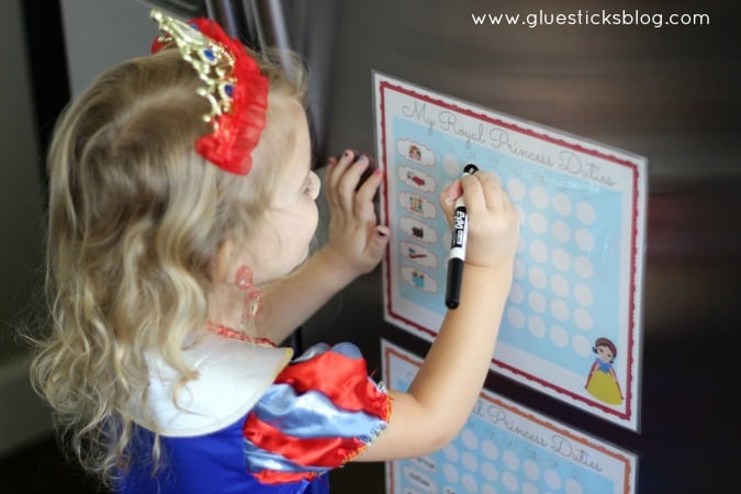 little girl marking off chores on her chart