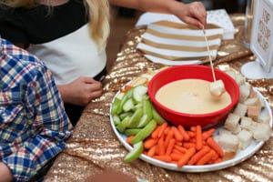 children dipping bread into cheese fondue