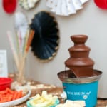 chocolate fondue on table with fixing