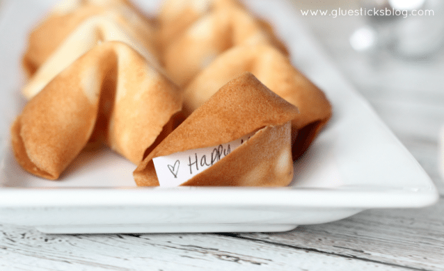 fortune cookie on platter with fortune sticking out