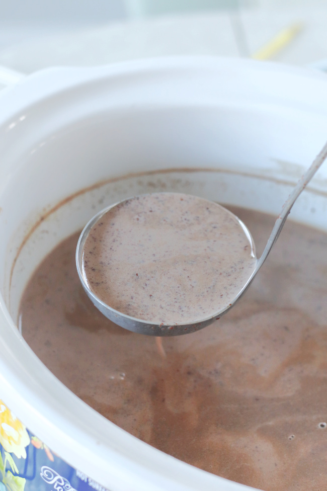 ladle of slow cooker hot chocolate