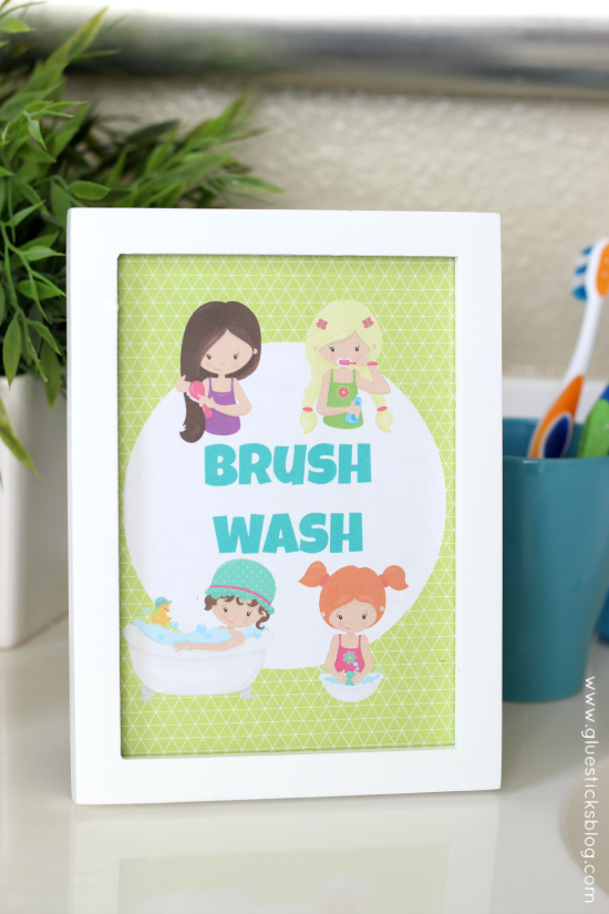 kids bathroom printable in white frame on counter