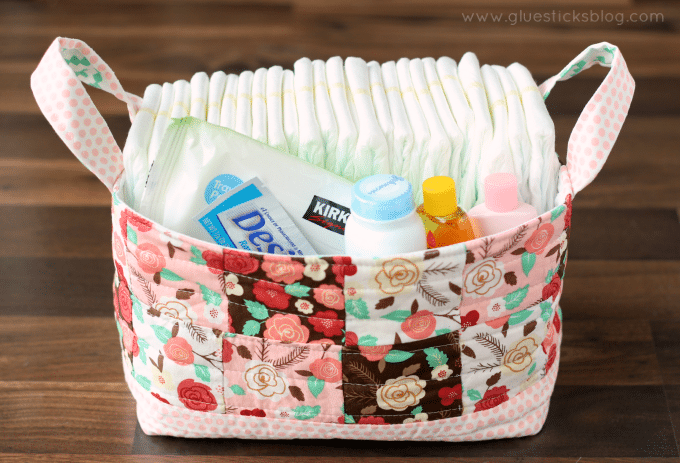 fabric basket filled with diapers and baby supplies