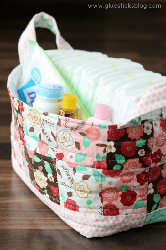 fabric gift basket with diapers and baby supplies inside