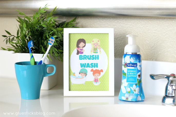 white frame, bottle of hand soap and cup with toothbrushes