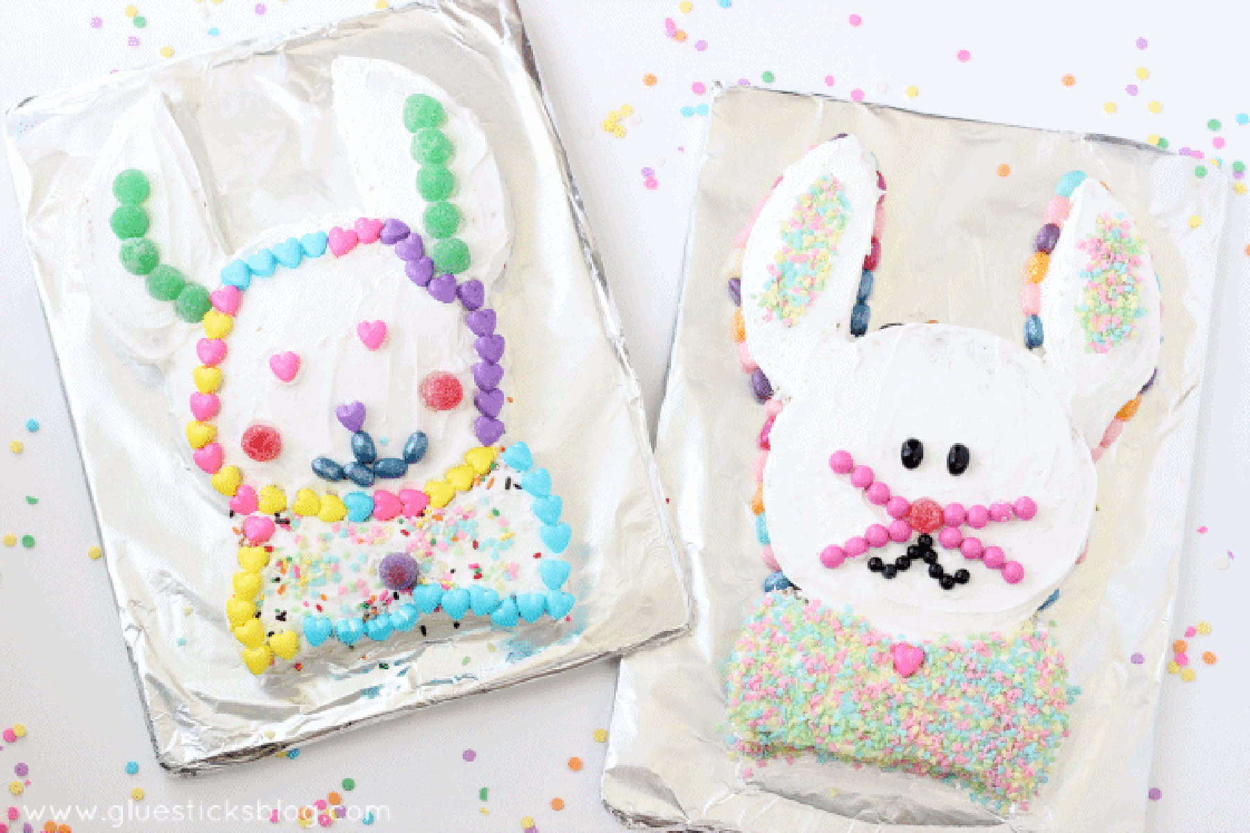 Two white Easter bunny cakes on foil cake boards.