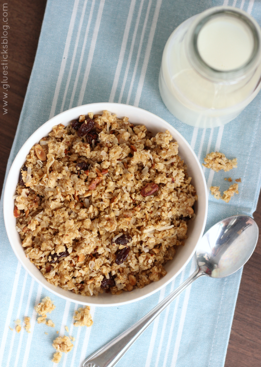 granola in bowl with bottle of milk and spoon