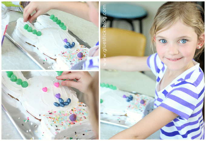 little girl decorating bunny cake