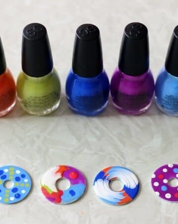 nail polish bottles lined up with finished washers painted