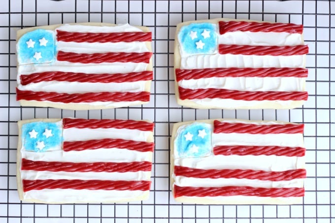 These flag sugar cookies are so easy to make with rectangle cookies and red licorice! Planning a BBQ for Memorial Day or the 4th of July? Don't forget a sugar cookies station for the kids! 
