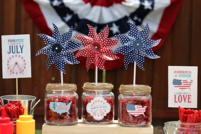 twizzler patriotic centerpieces in jars on table with pinwheels