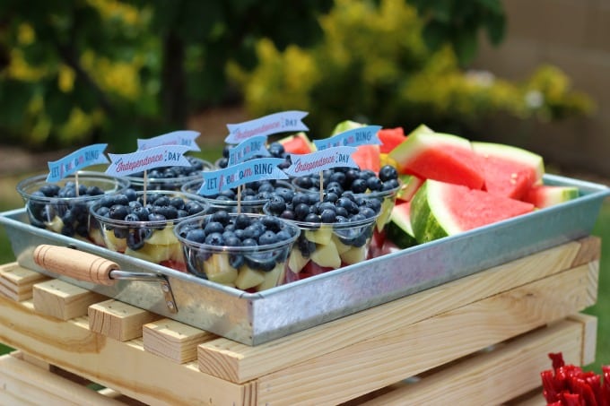 galvanized tray full of fruit cups and watermelon