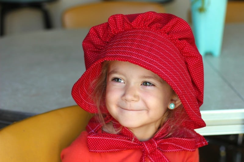 A simple elastic pioneer dress, apron, and bonnet. Perfect for any Pioneer Day or Little House on the Prairie activity! These homemade pioneer costumes are easy to make and so cute for little girls!