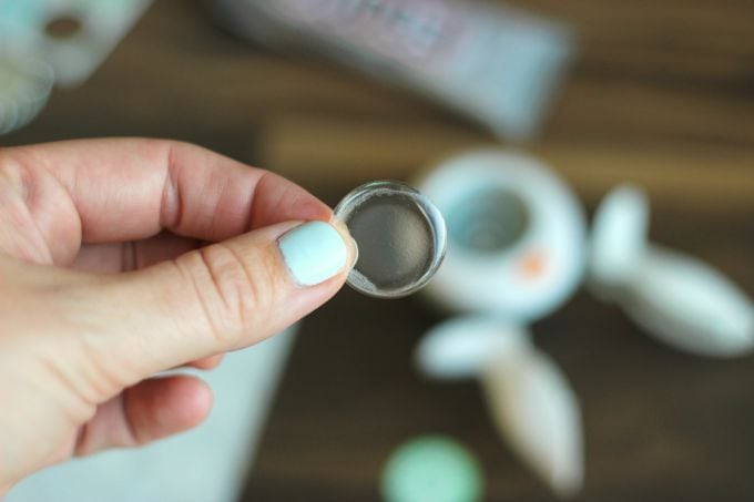 hand holding an acrylic circle sticker