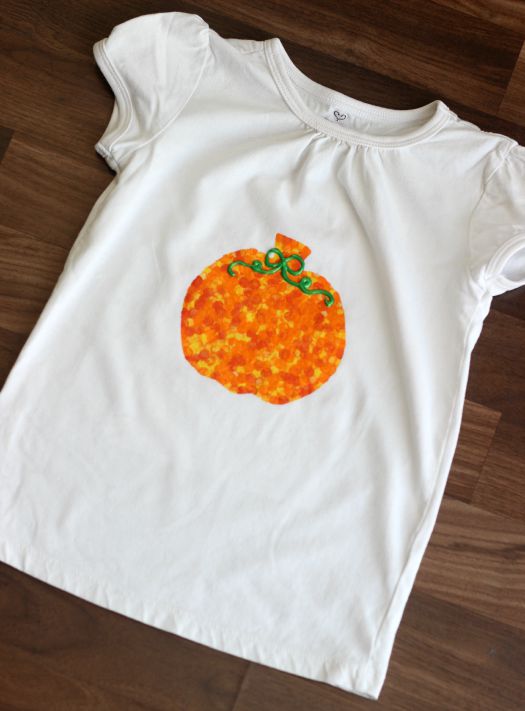 white kids t-shirt painted with a pumpkin on front