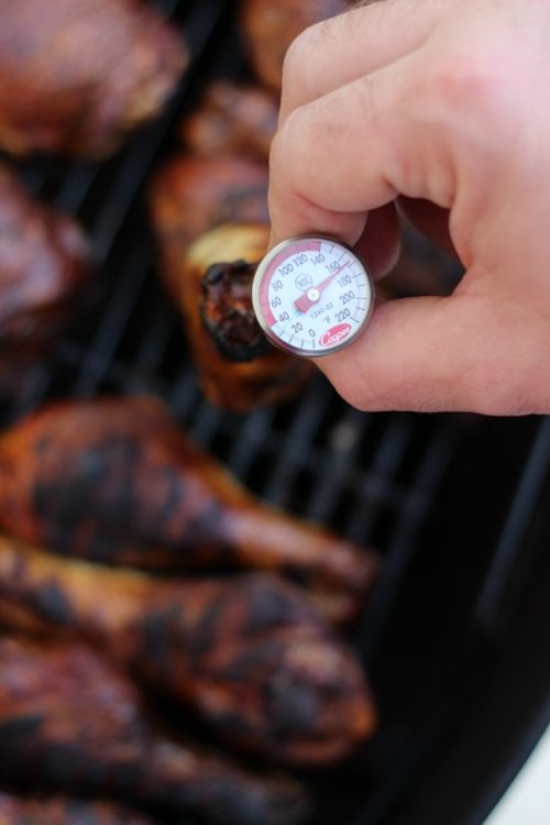 meat thermometer inserted into grilled chicken