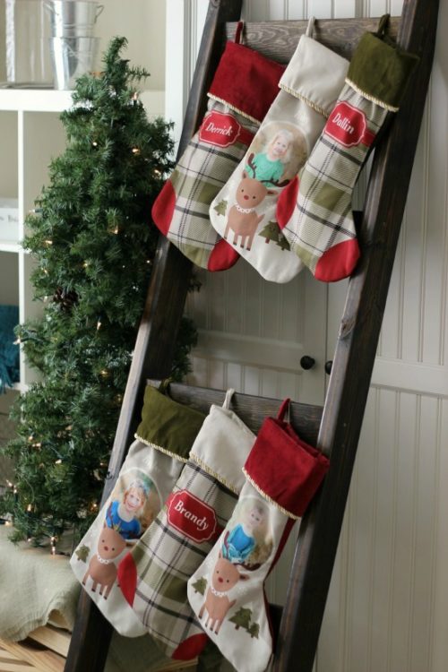 blanket ladder with 6 stockings strung from it to use as a stocking hanger