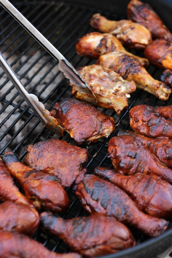 grilled chicken on grill brushed with bbq sauce