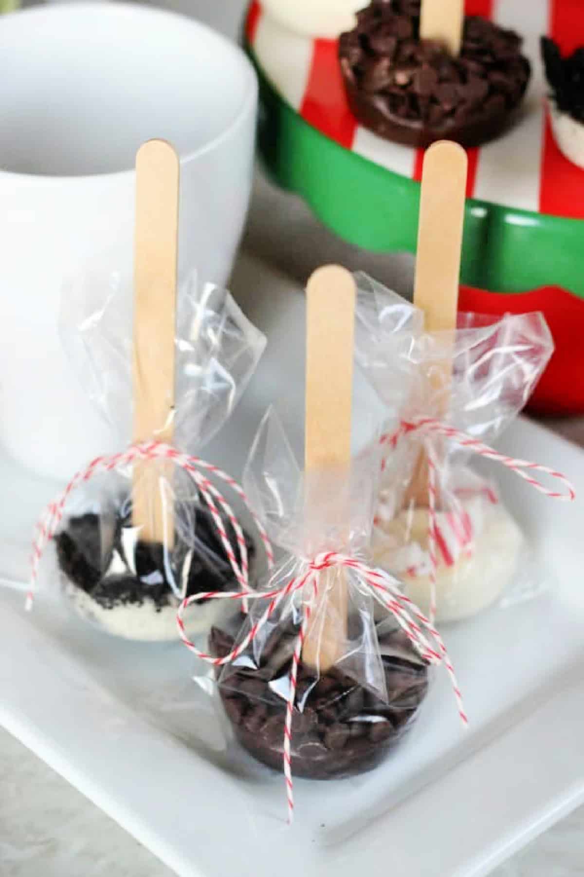 3 hot chocolate sticks on a plate.