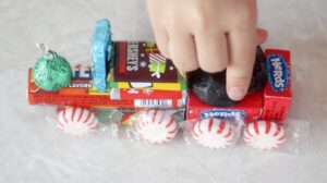 hand gluing chocolate coal to candy train