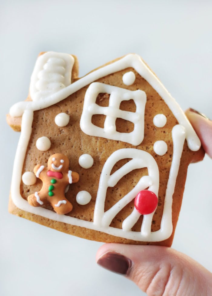 hand holding gingerbread house cookie