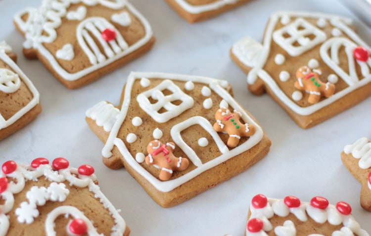 decorated gingerbread house cookies on parchment paper.