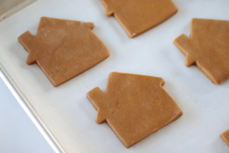 gingerbread cookie dough cut into house shapes.