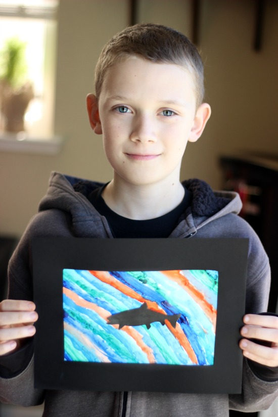 boy holding northern lights craft