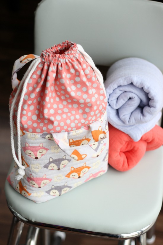 This cute fabric basket with an easy close drawstring can be used for things like toys, a mini diaper bag and more. It's a great baby shower gift!