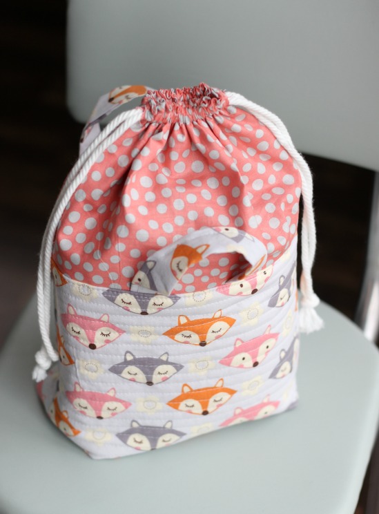 This cute fabric basket with an easy close drawstring can be used for things like toys, a mini diaper bag and more. It's a great baby shower gift!