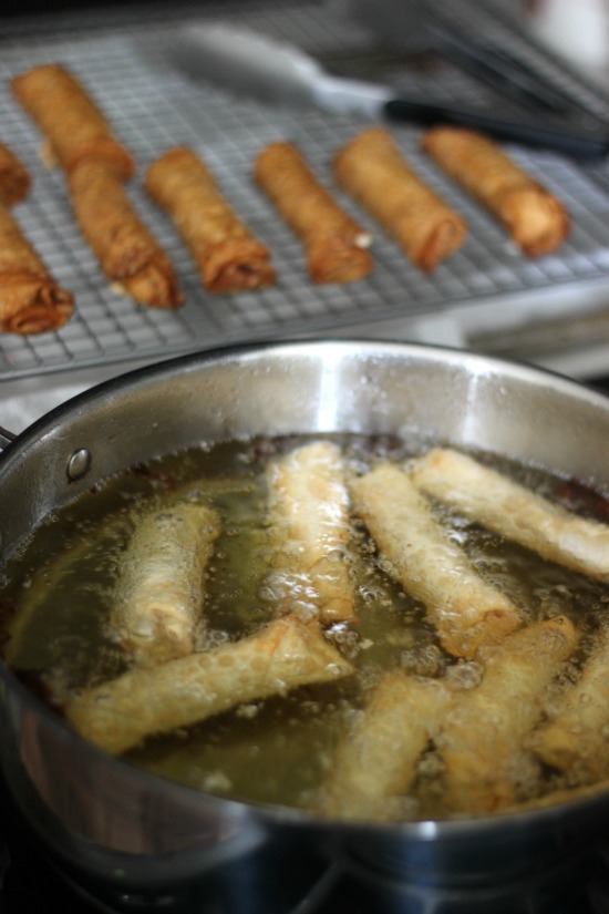 hot oil in pan frying egg rolls