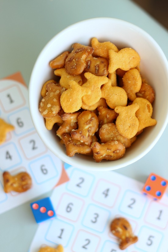 bowl of goldfish crackers next to game cards