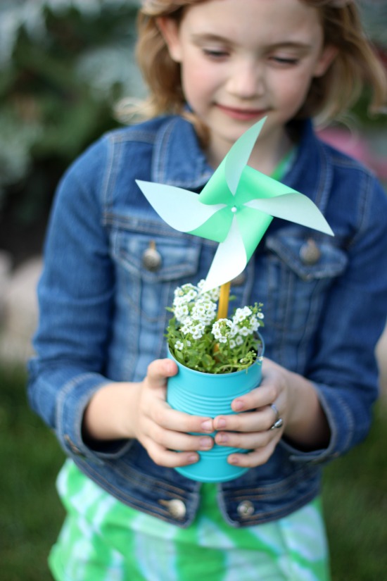 girl holding can with pinwheel