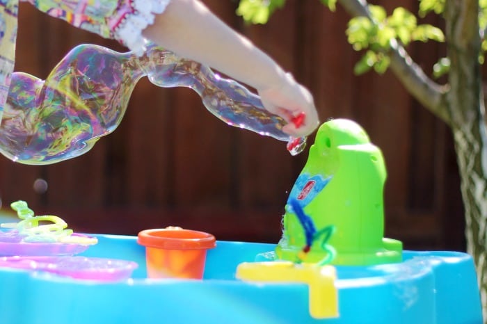 Make your own bubbles this summer with this 3 ingredient homemade bubble recipe. Simply combine water, dish soap, and glycerin! Fill up a large jug with homemade bubbles to have plenty on hand when spill happen, because they always do!