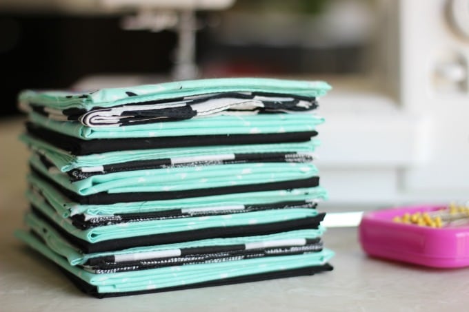 stack of bandannas on a table with sewing supplies