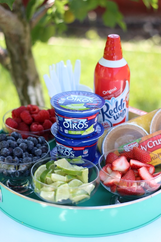 platter with limes, fruit, yogurt and mini pie crusts