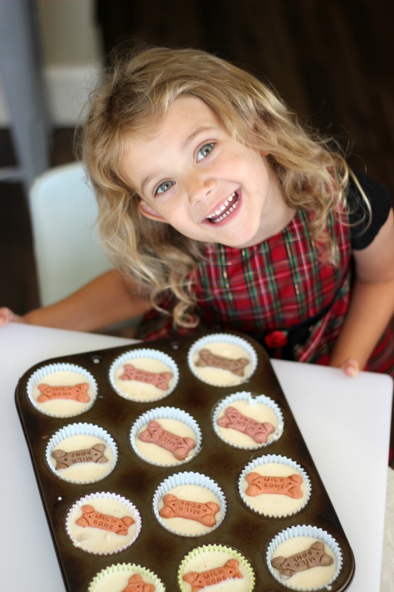 little girl next to tray of frozen dog treats