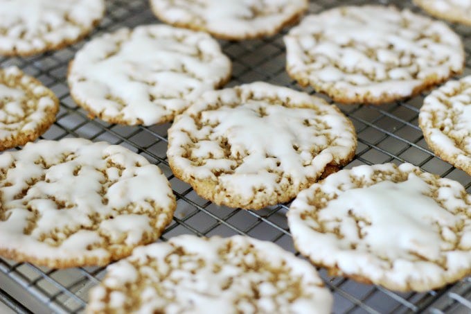 iced oatmeal cookies setting up on rack